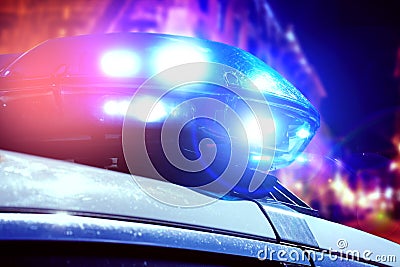 Blue and red light flasher of a patrol police car at night. Police force department in full activity with turned on lights. Night Stock Photo