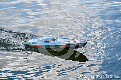 Blue Remote Boat racing on a blue lake on a summer day Editorial Stock Photo