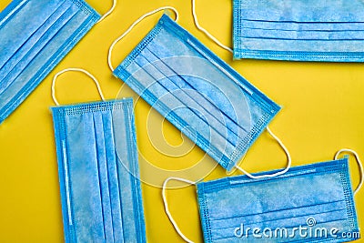 Blue respiratory masks on yellow background. Stock Photo