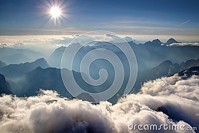 Blue ridges, hazy valleys and white clouds Julian Alps Slovenia Stock Photo