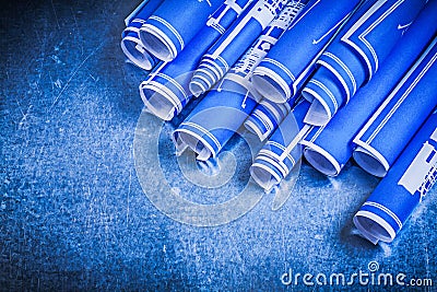 Blue rolled blueprints on metallic background construction conce Stock Photo