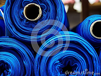 Blue rolls of knitted fabric. Classic blue color Stock Photo