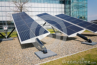 Blue rotating solar panels tilted axis tracker, future energy concept Stock Photo