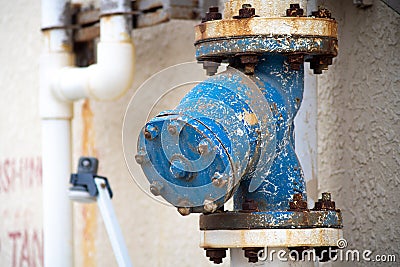 Blue rusted pipe joint with place to attach more pipes shows high diameter indistrial pipe joint Stock Photo