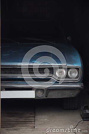 Blue rusty dusty american musclecar Plymouth Belvedere 1970 in the garage. Head lights Editorial Stock Photo