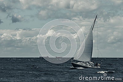 Blue sailboat at storm Stock Photo