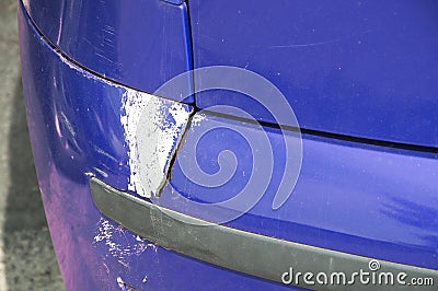 Blue scratched car with damaged paint in crash accident or parking lot and dented damage of metal body from collision Stock Photo