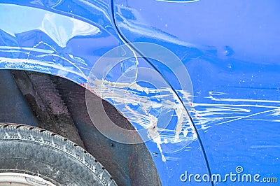 Blue scratched car with damaged paint in crash accident on the street or collision on parking lot in the city Stock Photo