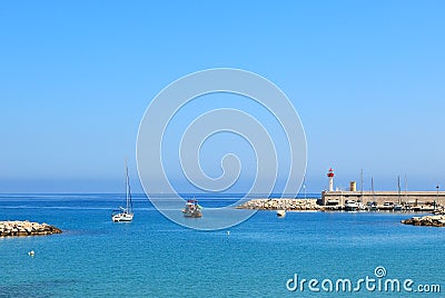 Blue sea at the entrance to marina of Menton, France. Stock Photo