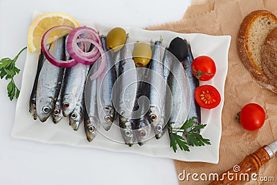 Blue sea fish, Sardines, ready for cooking with vegetables Stock Photo