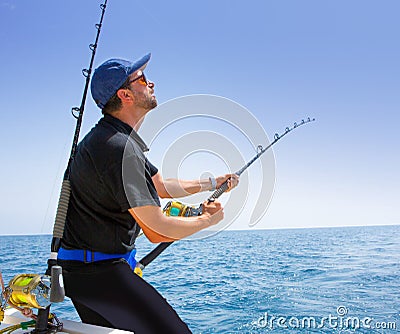 Blue sea offshore fishing boat with fisherman Stock Photo