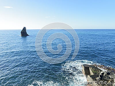 Blue sea, rock and stairs. Stock Photo