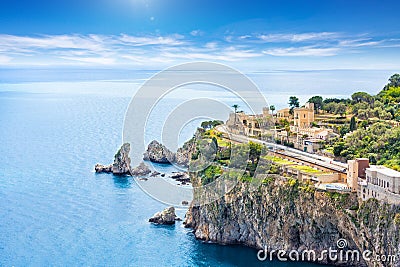 Blue sea and rocky coast at Cape Taormina. Taormina located in Metropolitan City of Messina, on east coast of island of Sicily, Stock Photo
