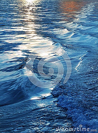 Blue sea water waves sunset from ship wake Stock Photo