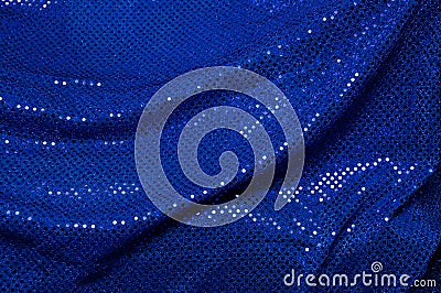 Blue sequined draped fabric background Stock Photo