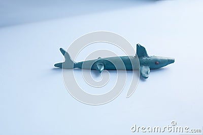 a blue shark made of plasticine on a blue background. Stock Photo