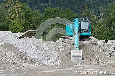 Blue shovel digger on gravel heap Stock Photo