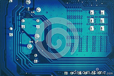 Blue side of motherboard circuit with soldered contacts and texture. High-tech abstract background with digital and new-age Stock Photo