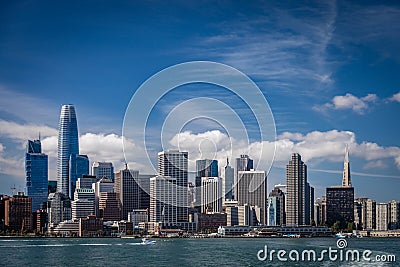 Blue skies with wispy clouds over the San Francisco skyline showing Salesforce tower on the left looking from across the Editorial Stock Photo