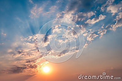 Blue sky background with evening fluffy curly rolling altocumulus altostratus clouds with setting sun. Good windy weather Stock Photo