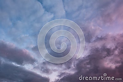 Blue sky background with evening fluffy curly rolling altocumulus altostratus clouds with setting sun. Good windy weather Stock Photo