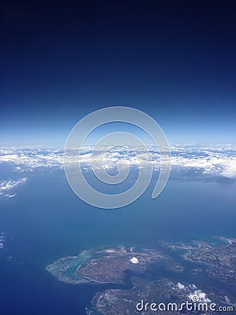 The blue sky and clouds, islands and the ocean, fly in the air Stock Photo