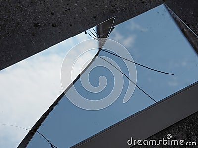 blue sky with clouds reflected on broken mirror Stock Photo