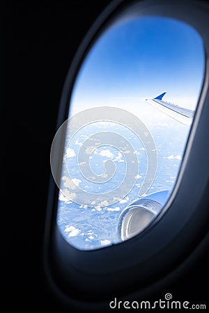 Blue Sky and Clouds Seen Through an Airplane Window Stock Photo