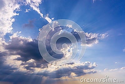 Blue sky with clouds and sun reflection,Sun beams or rays breaking through the dark clouds at sunset. Hope, prayer, God`s mercy Stock Photo