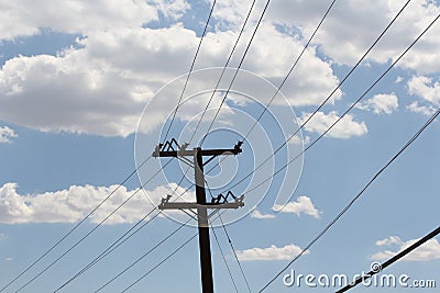 A blue sky with clouds and telephone wires. Stock Photo