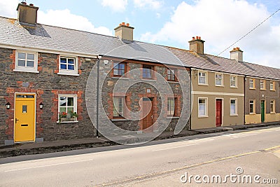 Blue sky with clouds and terraced houses in the village Dingle in county Kerry in Ireland in the summer. Editorial Stock Photo