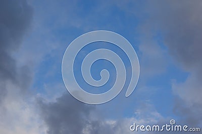 Blue sky grey puffy clouds Stock Photo