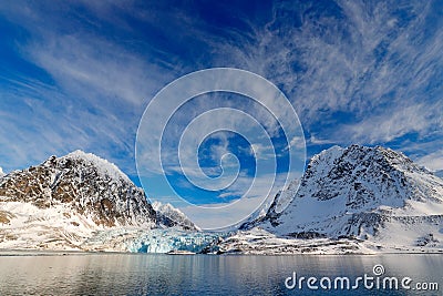 Blue sky with ice floe. Beautiful landscape. Cold sea water. Land of ice. Travelling in Arctic Norway. White snowy mountain, blue Stock Photo