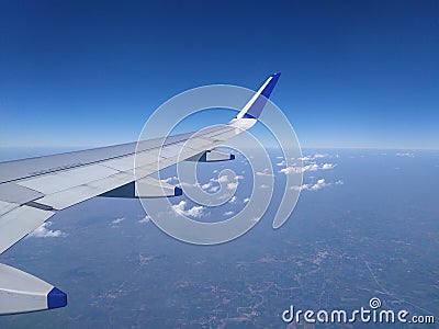 Blue sky and small scattered clouds from airplane window Editorial Stock Photo