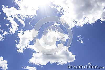 A blue sky with a sunlight. Cloud in the blue sky with God lights. A beautiful clouds against the blue sky background. Beautiful Stock Photo