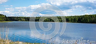 Blue sky with white clouds. Forest on the banks of the river. Stock Photo