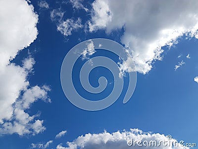 Blue sky with white cumulus clouds on a sunny clear day. Natural background for later design. Prediction of weather on the circula Stock Photo