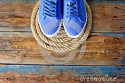 Blue sneakers shoes on a rope spiral Stock Photo