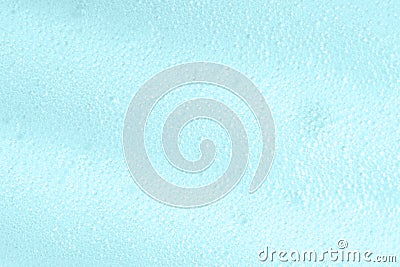 Blue soapy surface closeup. Foamy cleansing skin care product texture from soap, shaving foam or cleanser. Foam macro Stock Photo