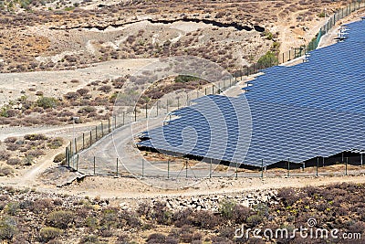 Blue solar panels at photovoltaics power station farm, future innovation energy concept, clear blue sky background Stock Photo