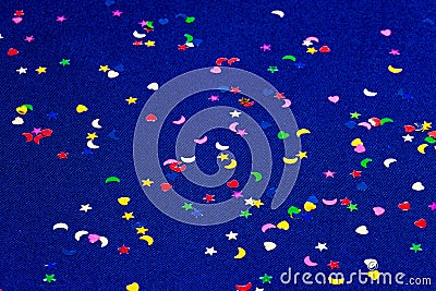 Blue sparkling and glitter background witl little hearts, stars and moons. Top view. Stock Photo