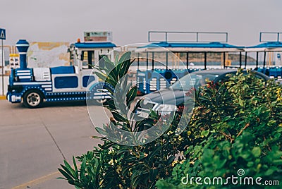 A blue steam locomotive drives through the streets of the city of Crete Editorial Stock Photo