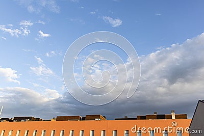 Blue stormy landscape sky on a building roof facade Stock Photo