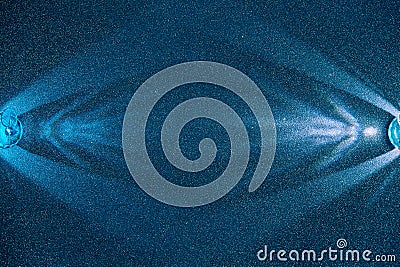 On a blue structural fine-grained background, light blue rays of light Stock Photo