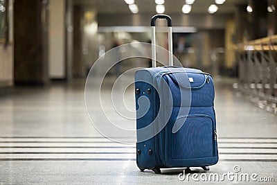 Blue suitcase at airport Stock Photo