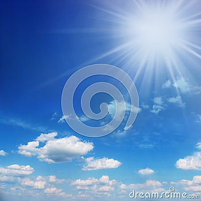 Blue and sunny sky with sun over the clouds Stock Photo