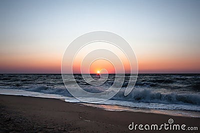 Blue sunrise on the sea coast. Sunrise on a wild sea beach. Sea water ocean wave. Ocean view beach. Summer tourism. Beautiful sunr Stock Photo