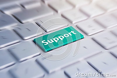 Blue support keyboard button. Green Button on Computer Keyboard. blurred in motion background. Stock Photo