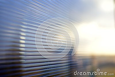 Blue surface of striped polycarbonate with a reflection of the blue distance of the city Stock Photo
