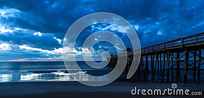 Blue Swirl sunrise under Pier Stock Photo